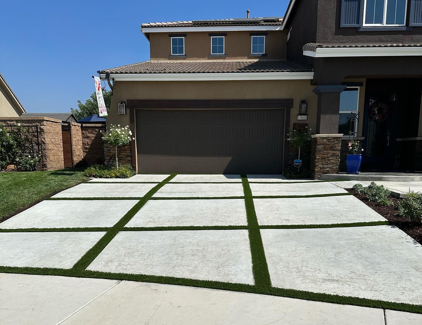 Pour & stamped concrete driveway! & Greenridge Turf Stips, Riverside Create a Driveway That Stands Out A combination of concrete pavers and artificial grass can turn an ordinary driveway into an attractive landscape feature. Whether you prefer a simple border, turf strips between pavers, or a more creative geometric design, the possibilities can be customized to your property.
